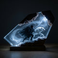 Winter's Charge resin lamp glowing in a dark room